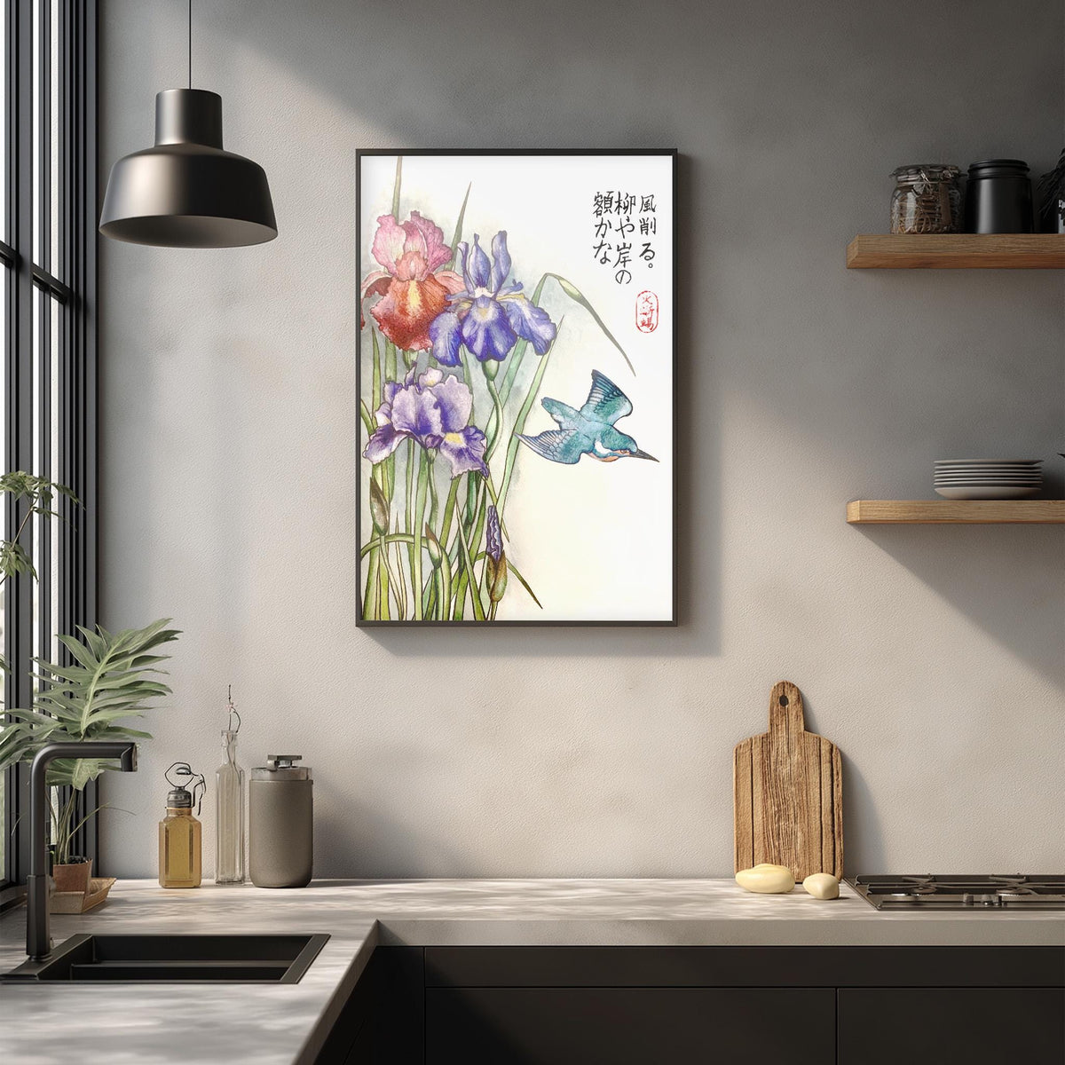 a framed painting of colorful flowers hanging on a wall above a kitchen counter.