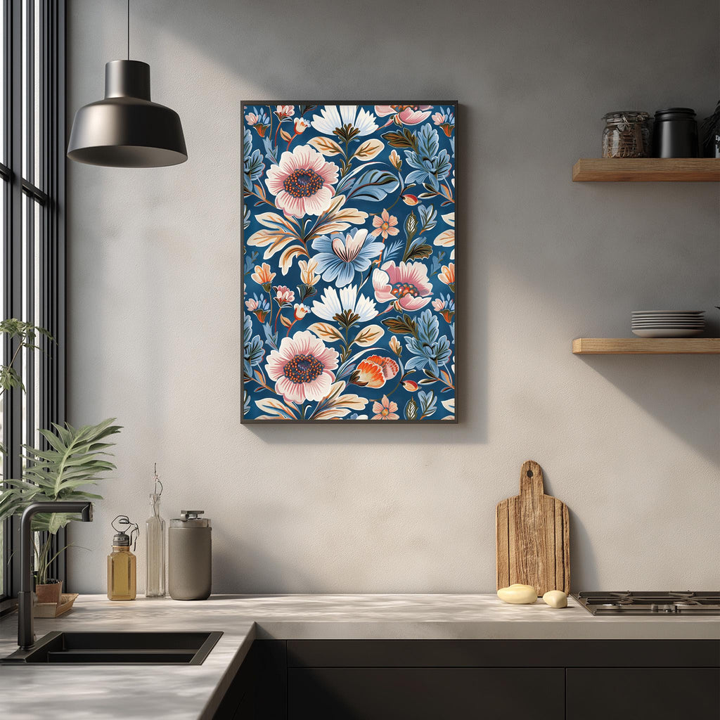 a kitchen counter with a wooden cutting board, a potted plant, and a framed floral print hanging on the wall above the counter.