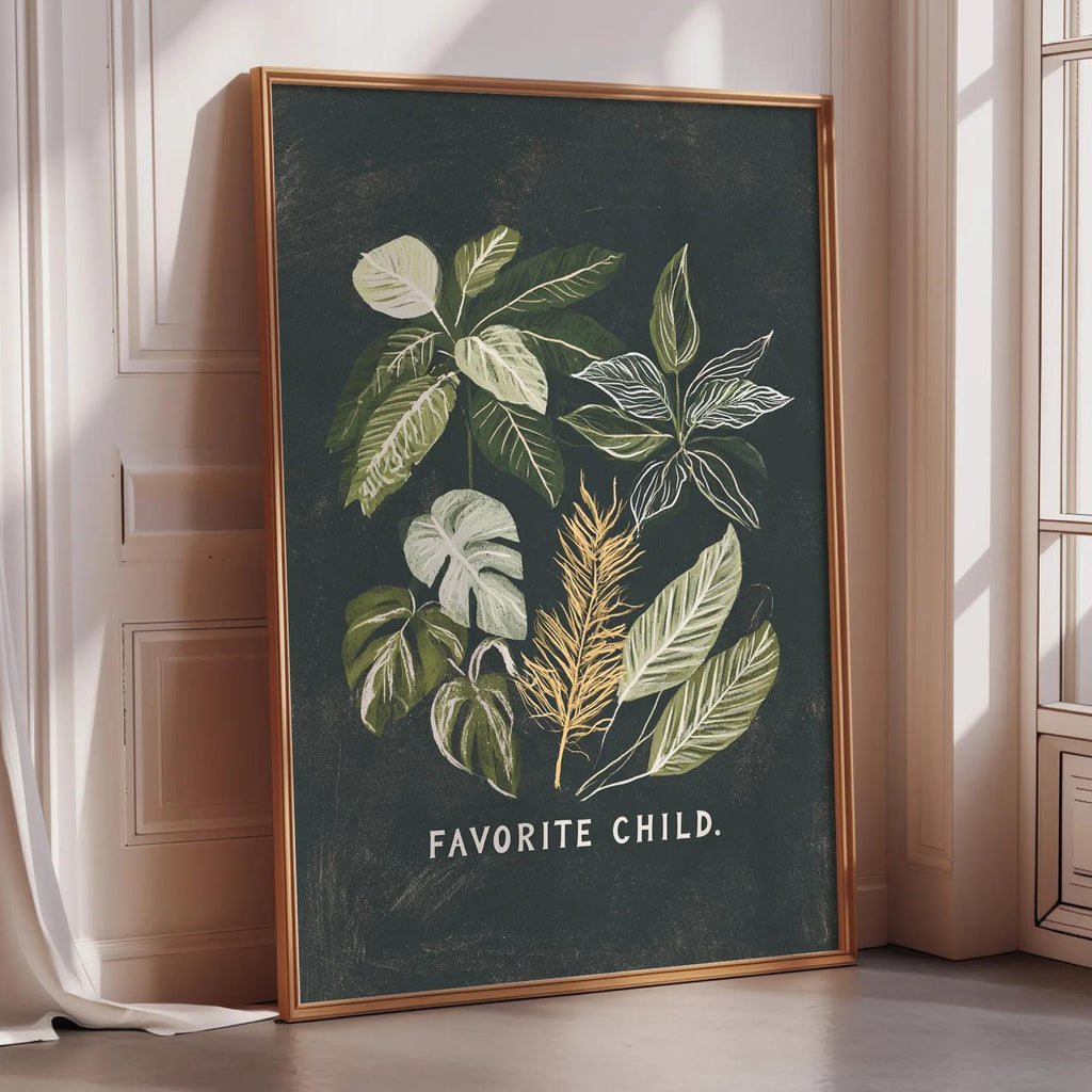 a framed poster with a black background and a collage of green leaves and plants. The text on the poster says "Favored Child."