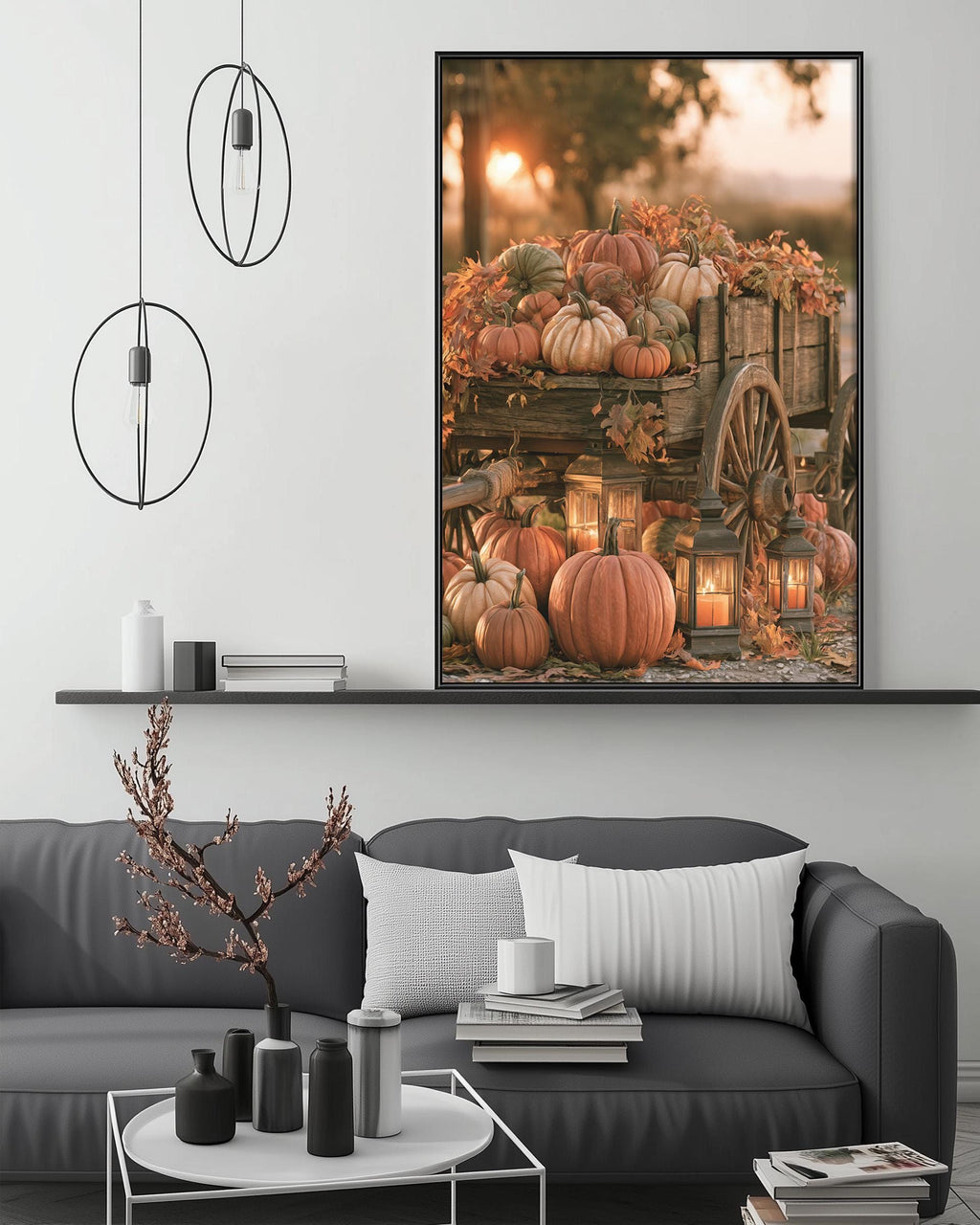 a cozy living room with a gray sofa, a coffee table, and a large framed picture of pumpkins and lanterns hanging on the wall.