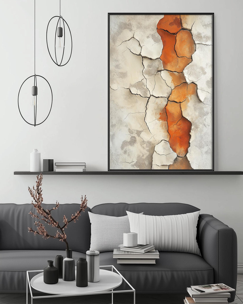 a modern living room with a gray sofa, a coffee table, and a large abstract painting hanging on the wall above the sofa.