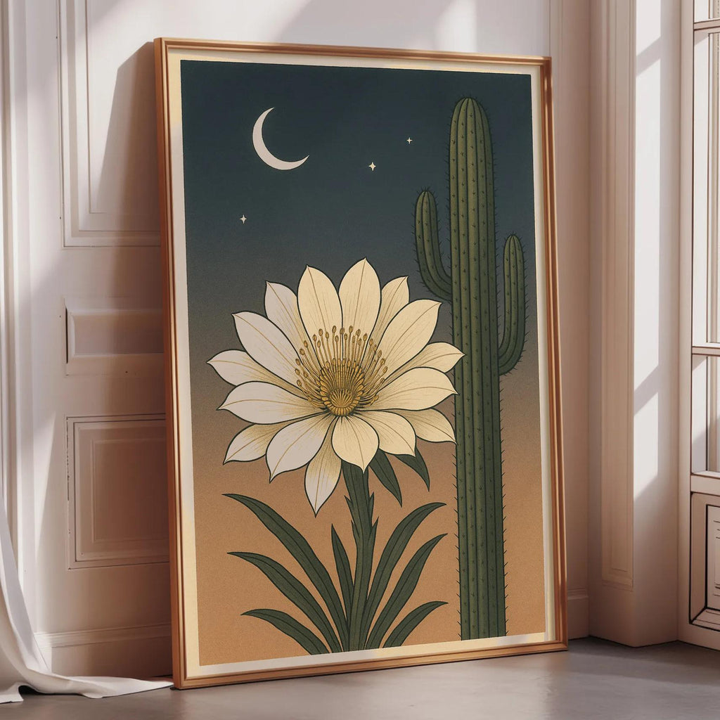 a framed illustration of a cactus with a large white flower on its side, set against a night sky with a crescent moon and stars.