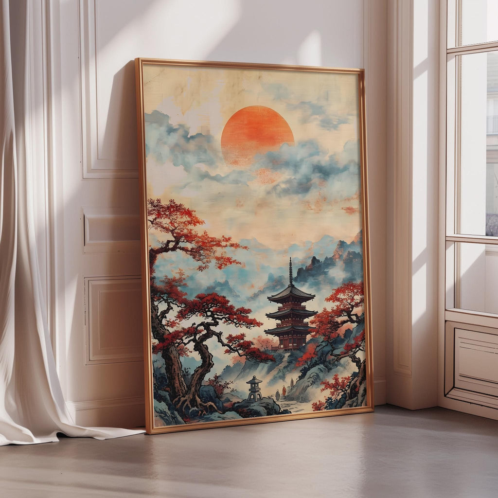 A large framed painting depicting a serene landscape with a pagoda in the background, surrounded by trees with red leaves, and a large orange sun in the sky.