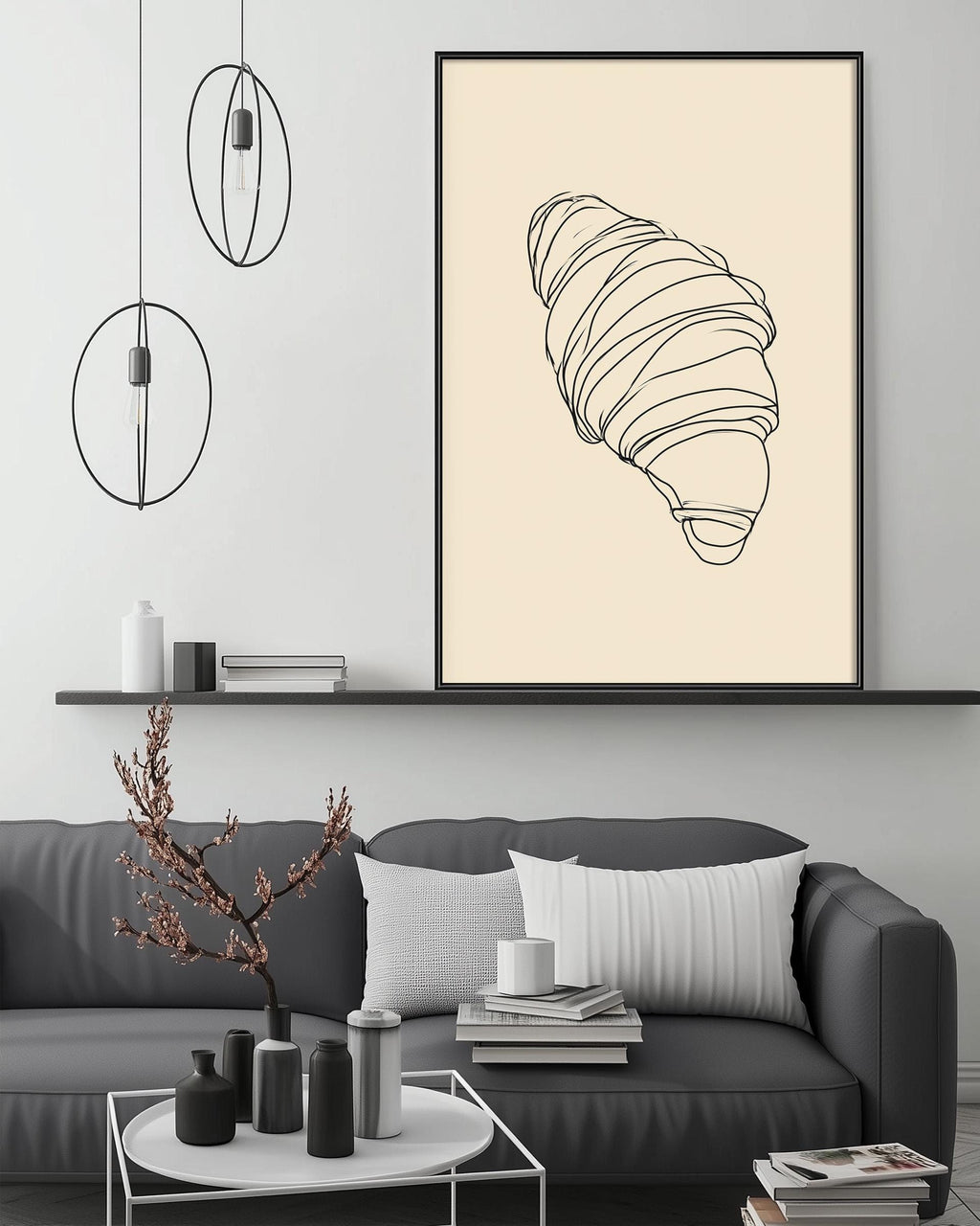 a modern living room with a gray sofa, a coffee table, and a large framed illustration of a croissant on the wall.