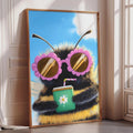 A framed illustration of a bee wearing pink sunglasses and holding a green drink with a flower on it, set against a blue sky background.