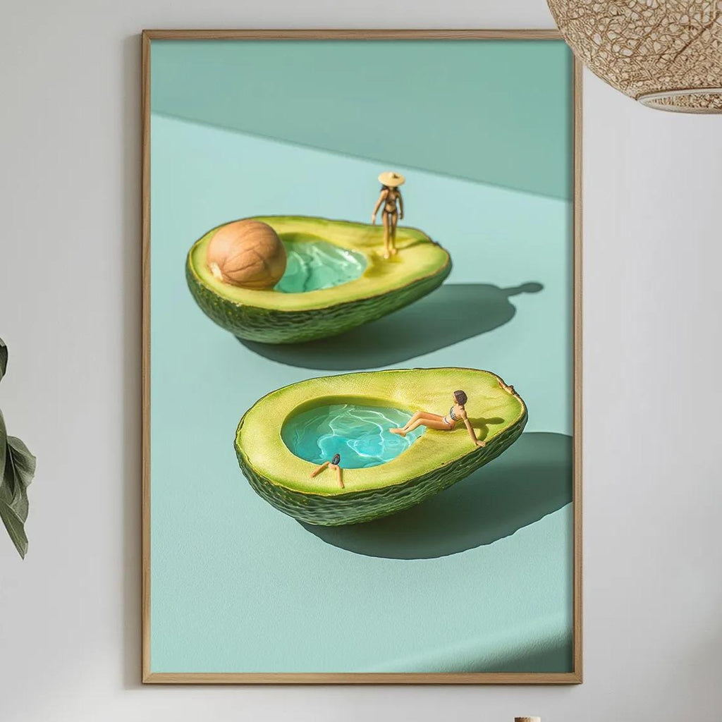 a dining table with a white tablecloth, a bottle, a bowl, and a vase with flowers. Above the table, there is a framed picture of two avocados with people in them, and a hanging light fixture.