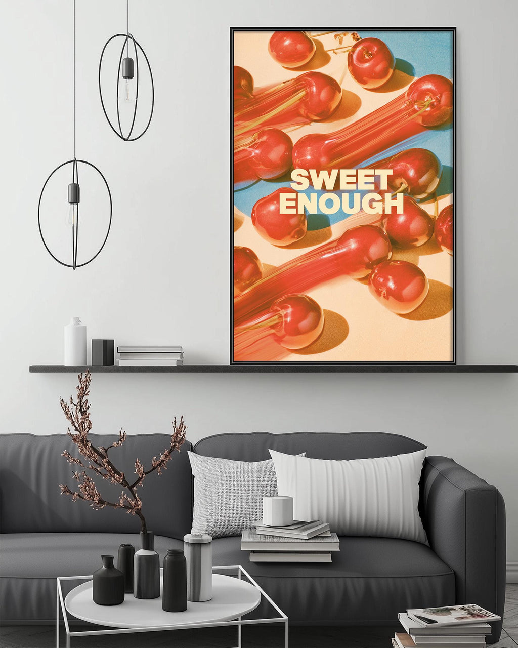 a modern living room with a gray sofa, a coffee table, and a large framed poster of red peppers hanging on the wall.