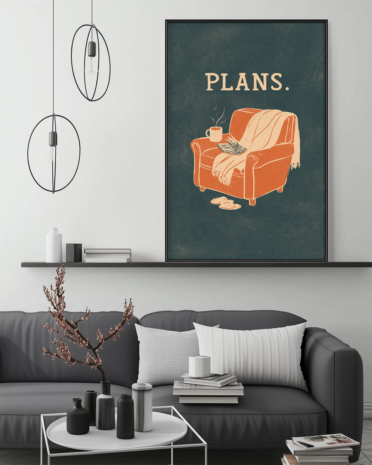 a cozy living room with a gray couch, a coffee table, and a framed poster with an illustration of a chair and a blanket.