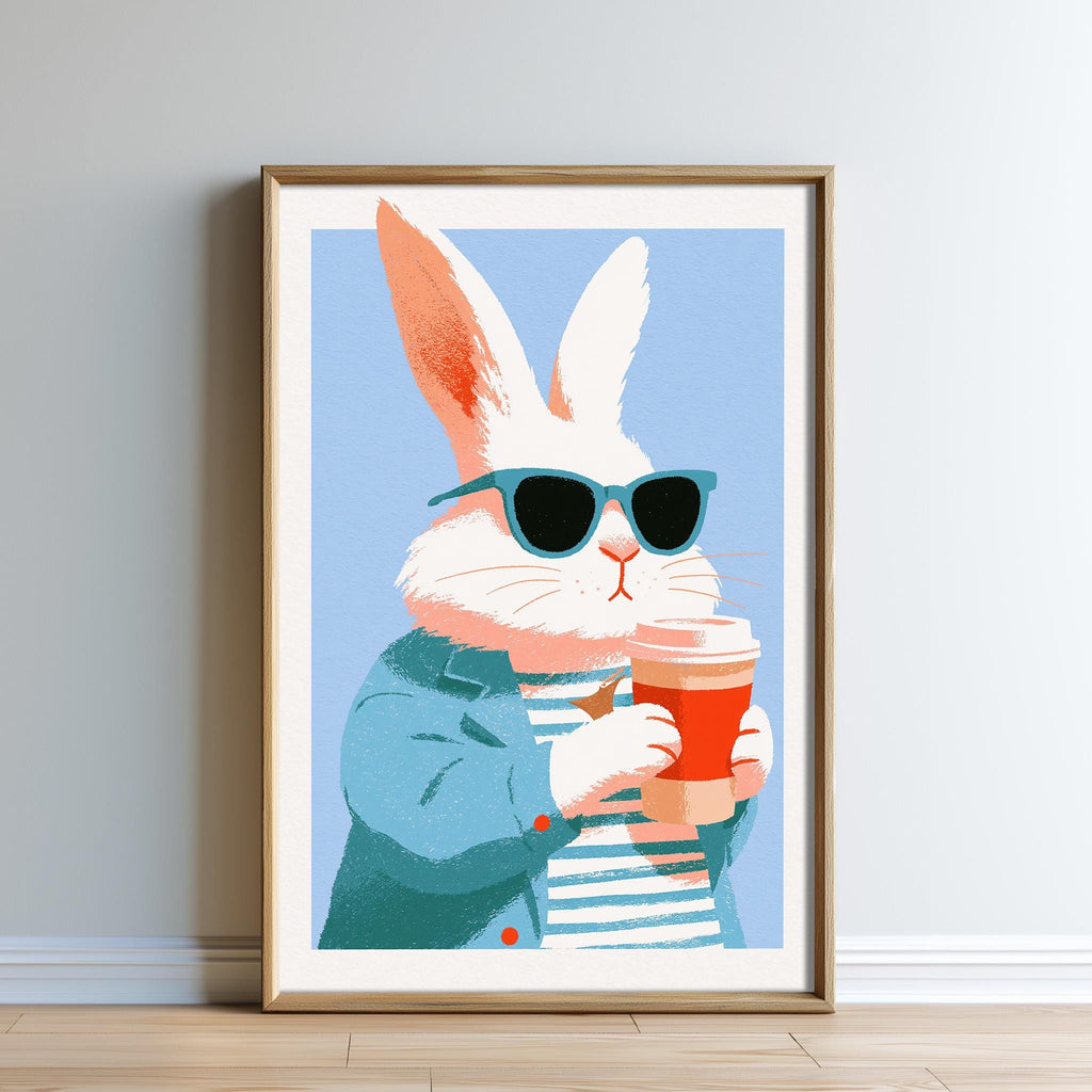 A framed illustration of a white rabbit wearing sunglasses and holding a red cup.