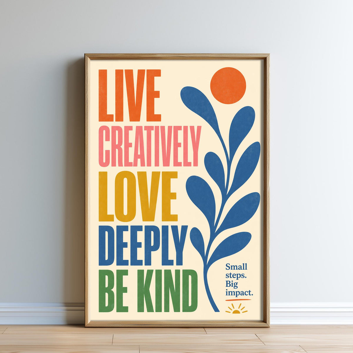 The image is a framed poster with a vibrant design featuring a sun and leaves, accompanied by the text "Live Creatively, Love Deeply, Be Kind" in a colorful, artistic style.