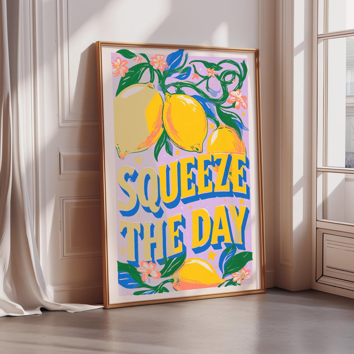 A framed poster with a vibrant design featuring lemons and the text "SQUEEZE THE DAY" is displayed on a wall.