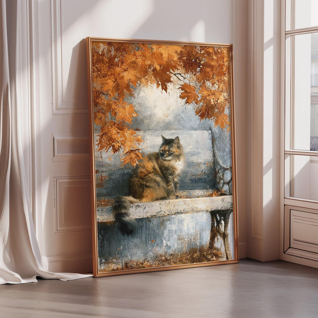 A framed painting depicting a cat sitting on a bench with autumn leaves in the background.