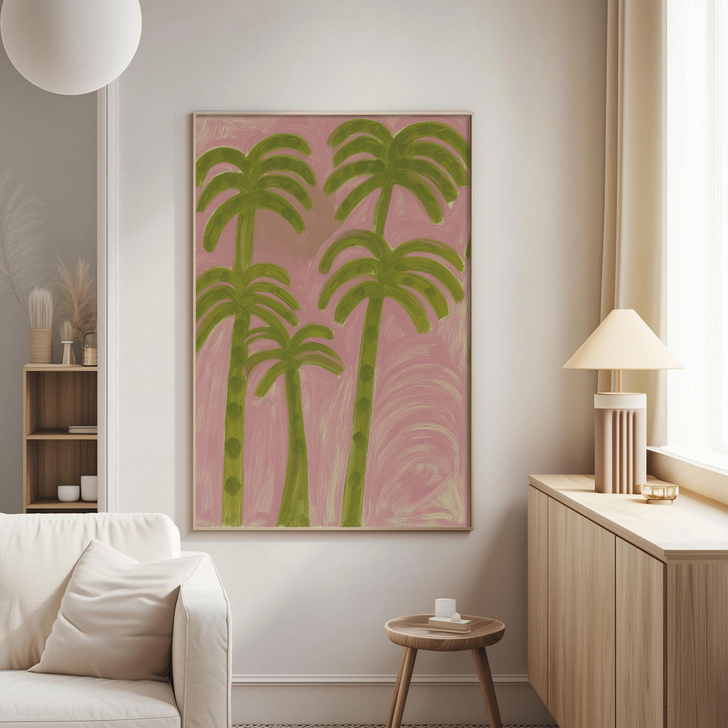 a living room with a large framed painting of palm trees hanging on the wall. The painting has a pink background and green palm trees. The room also includes a white sofa, a wooden side table, and a lamp on a wooden cabinet.
