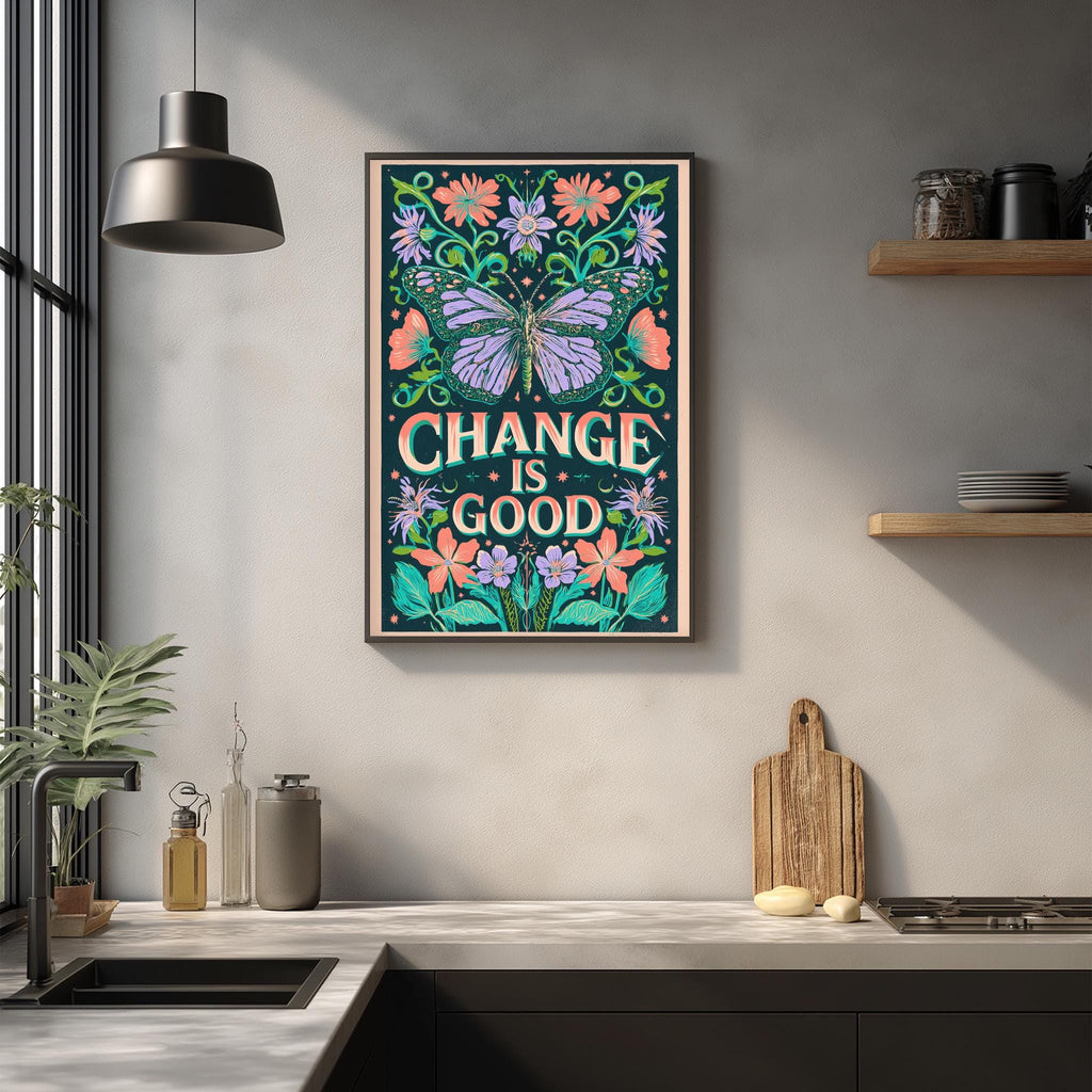 a framed poster with the text "CHANGE IS GOOD" hanging on a wall above a kitchen counter.