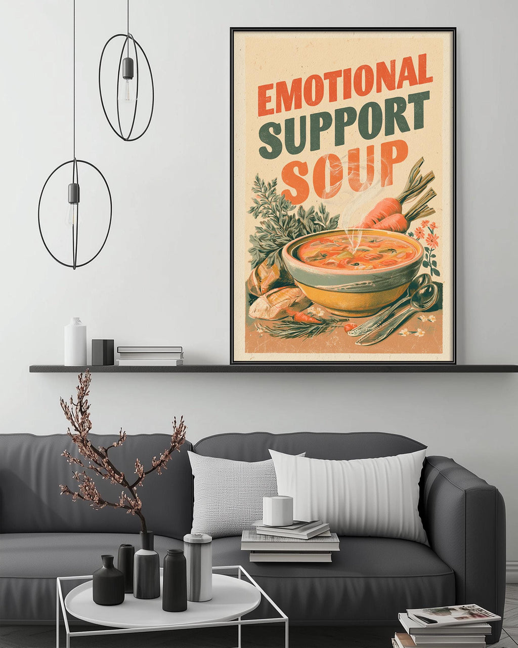 a cozy living room with a gray couch, a coffee table, and a framed poster of a bowl of soup hanging on the wall.
