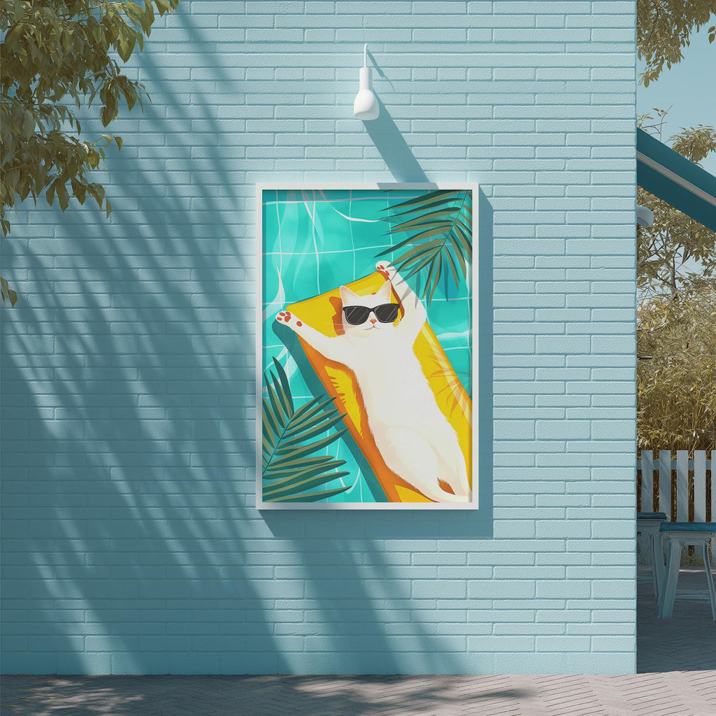 A framed illustration of a cat lounging on a yellow float in a swimming pool, surrounded by palm leaves, is displayed on a blue wall.