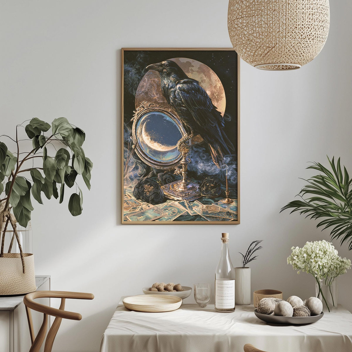 a large framed painting of a black crow perched on a crescent moon, surrounded by a night sky and stars, hanging on a white wall above a dining table with various decorative items and plants.