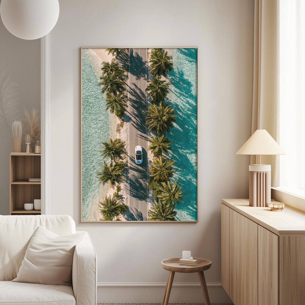 a large framed picture of a road lined with palm trees, with a car driving down the road, creating a serene and tropical atmosphere.