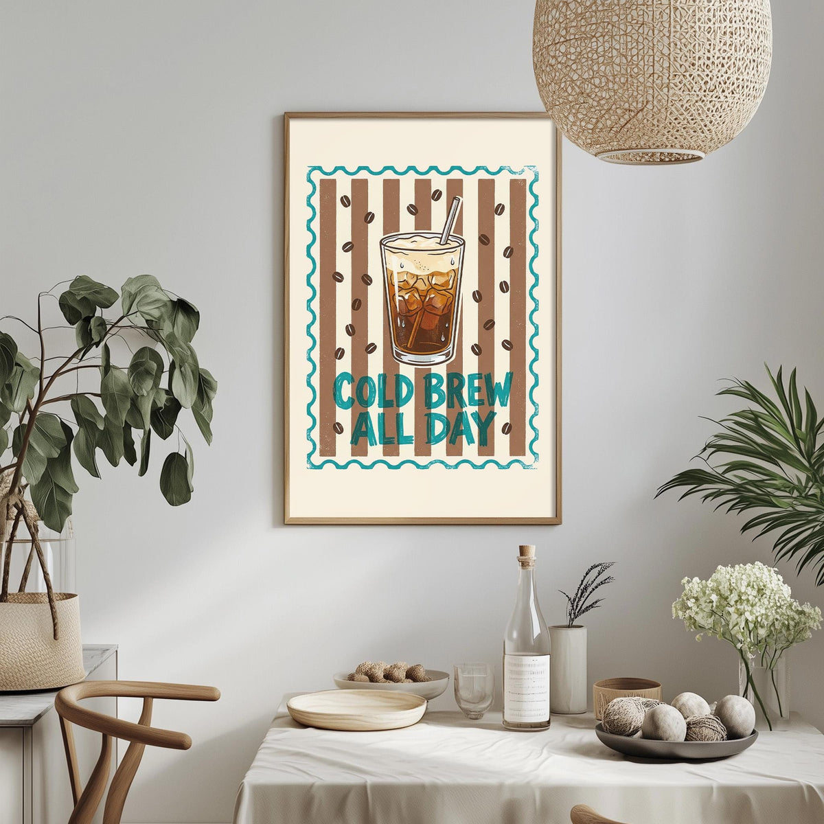 a framed poster with a coffee cup and the text "COLD BREW ALL DAY" hanging on a wall above a dining table with various items on it.