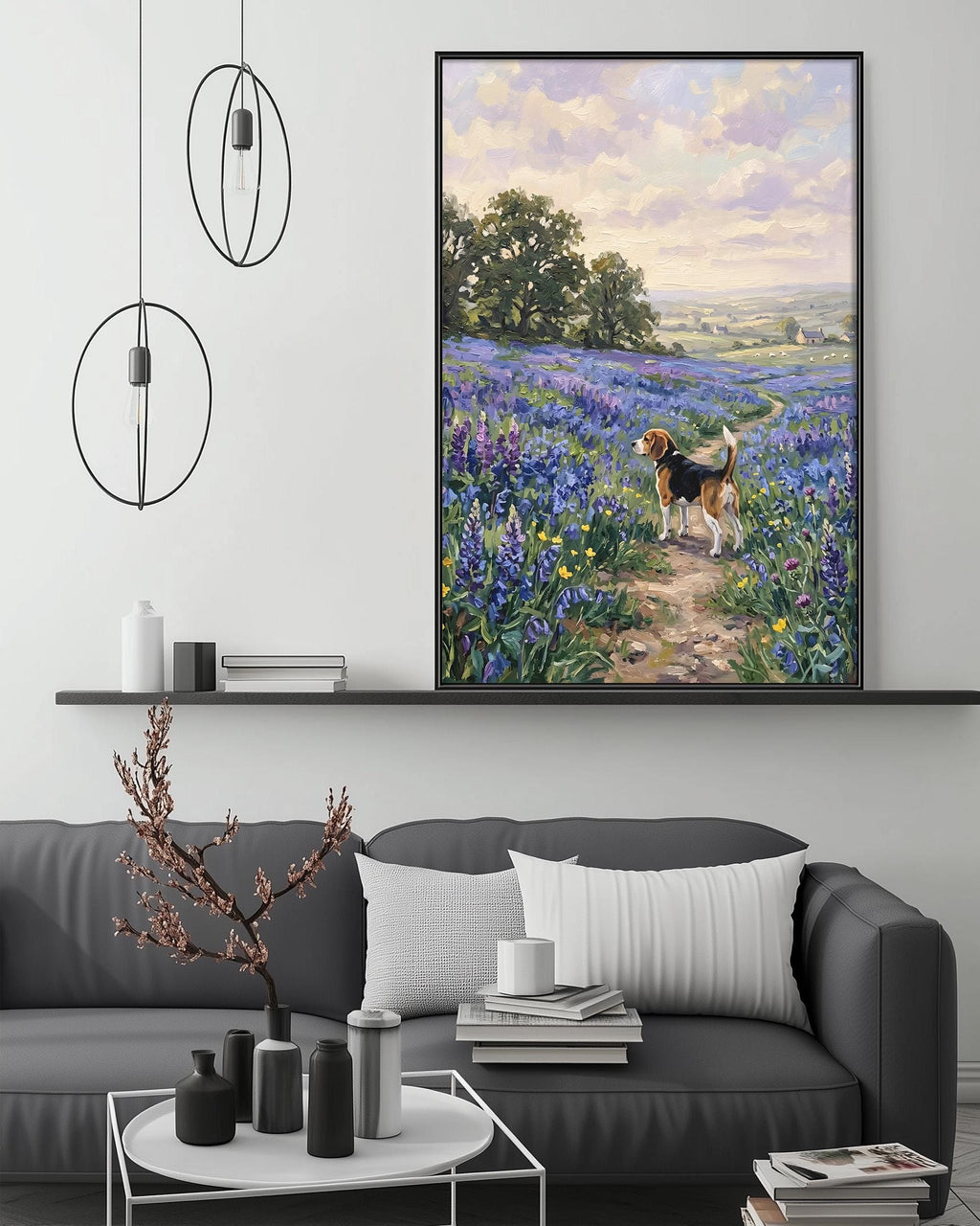 a large painting of a dog in a field of flowers, hanging on a wall above a gray couch with a coffee table in front of it.