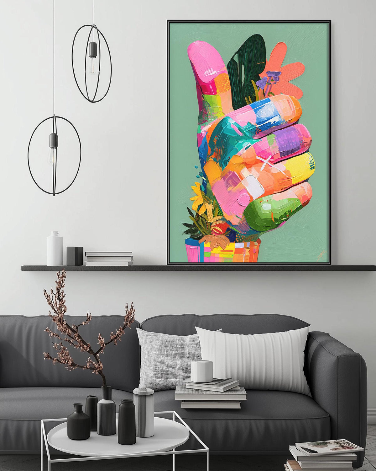 a modern living room with a gray sofa, a coffee table, and a large framed artwork of a colorful hand on the wall.