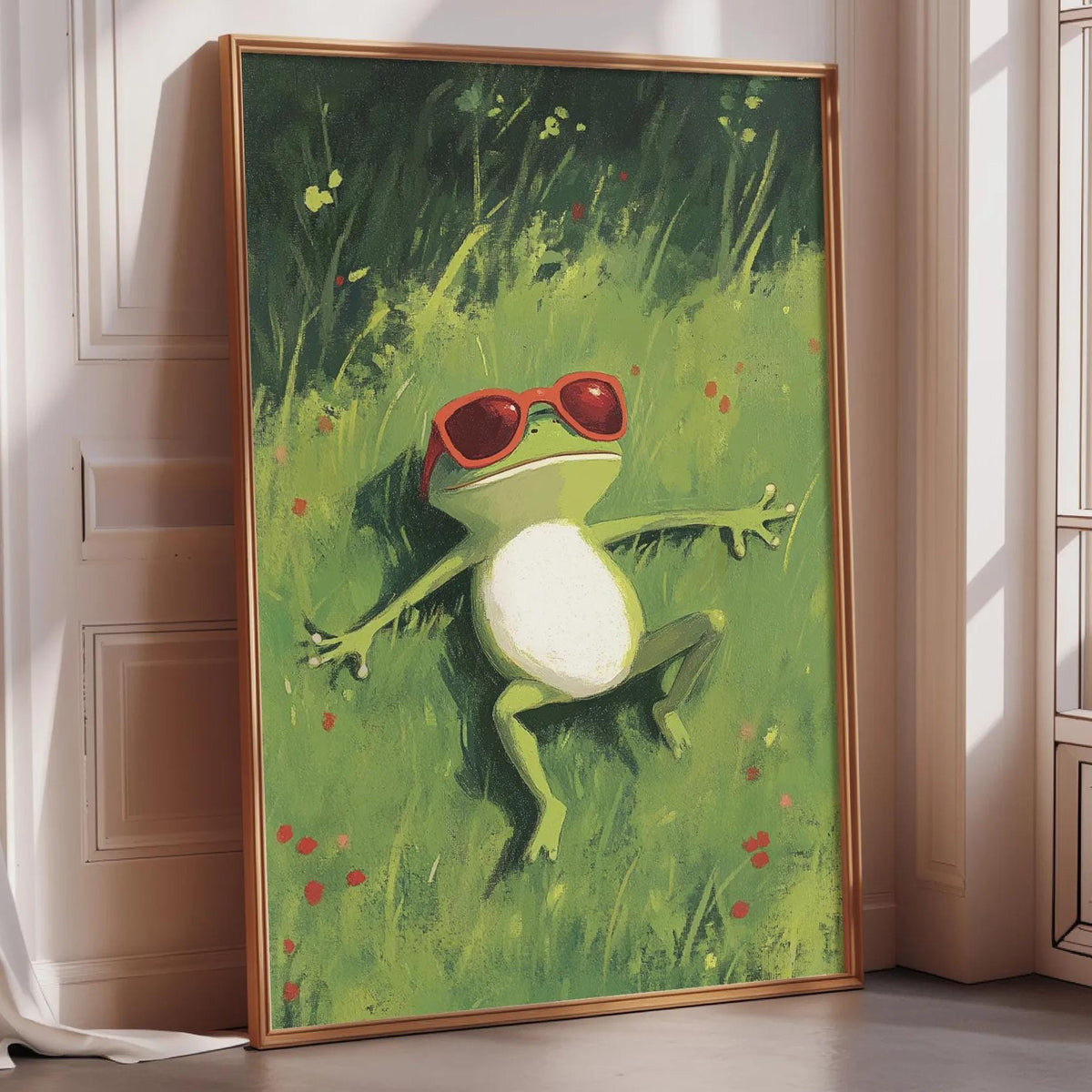 A framed painting of a green frog wearing red sunglasses, lying on a grassy field with flowers.