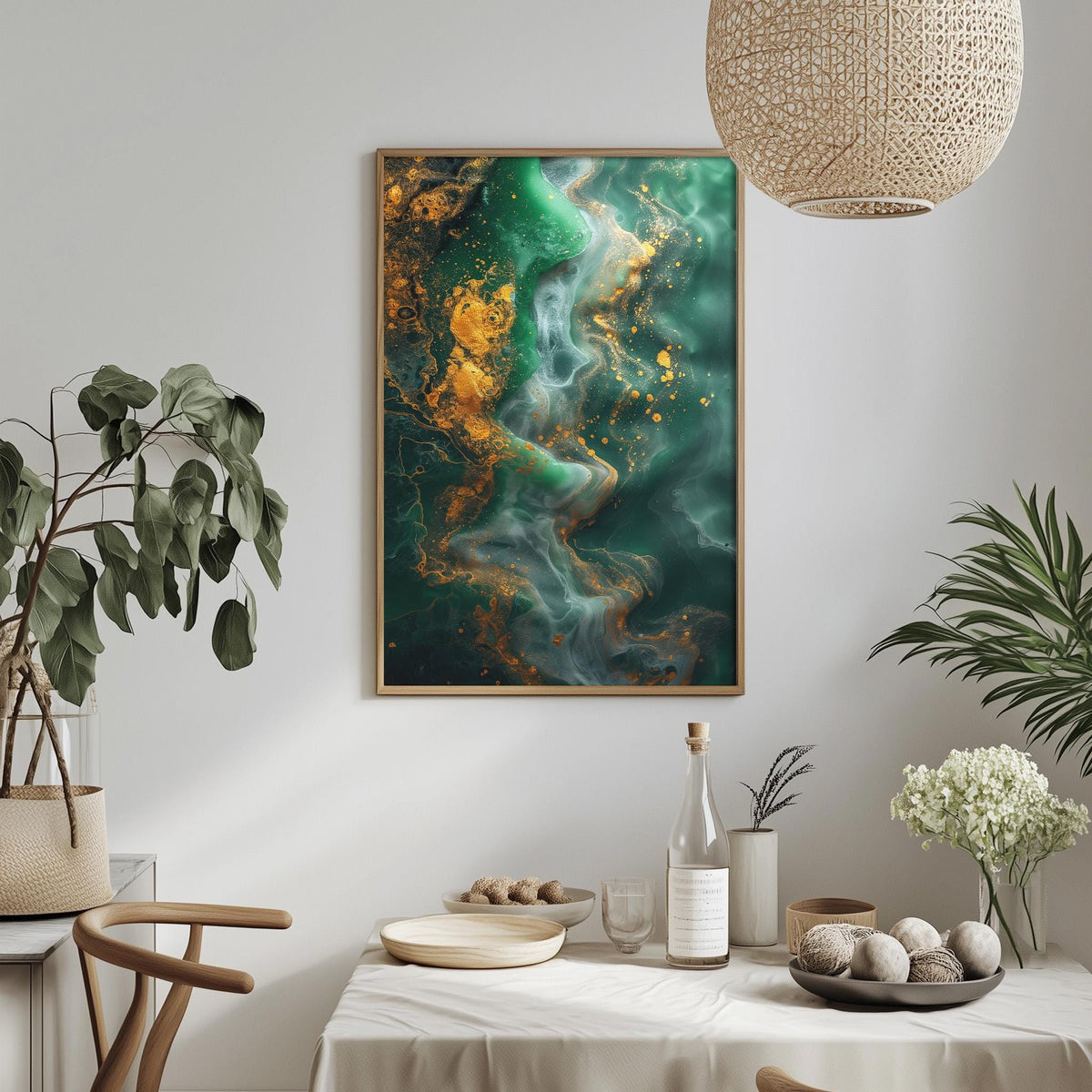 a dining table with a white tablecloth, a bowl of fruit, a bottle, and a vase with flowers. Above the table, there is a framed painting of a swirling green and yellow abstract design.