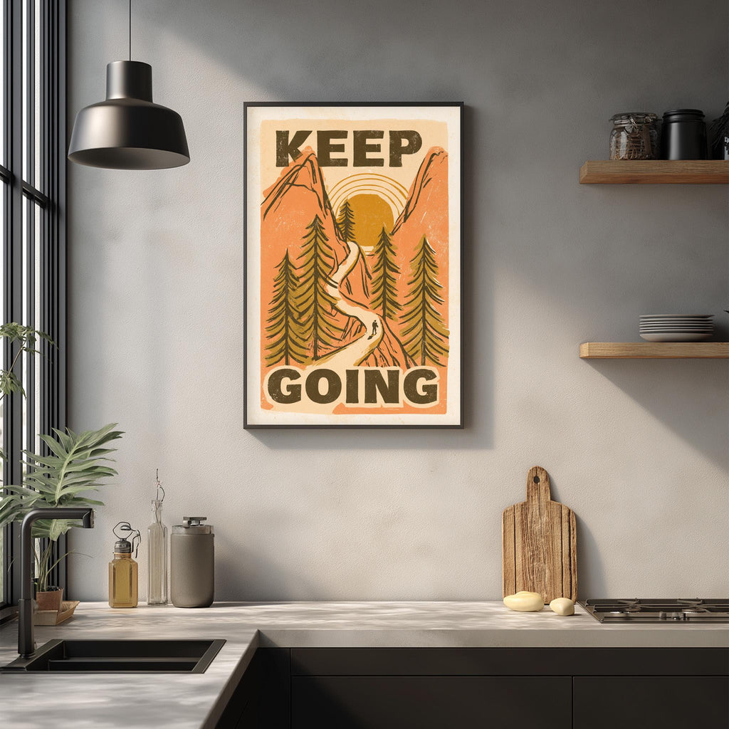 a kitchen counter with various kitchen items, such as a cutting board, a knife, and a bottle. Above the counter, there is a framed poster with the text "KEEP GOING" and an illustration of a mountain landscape.