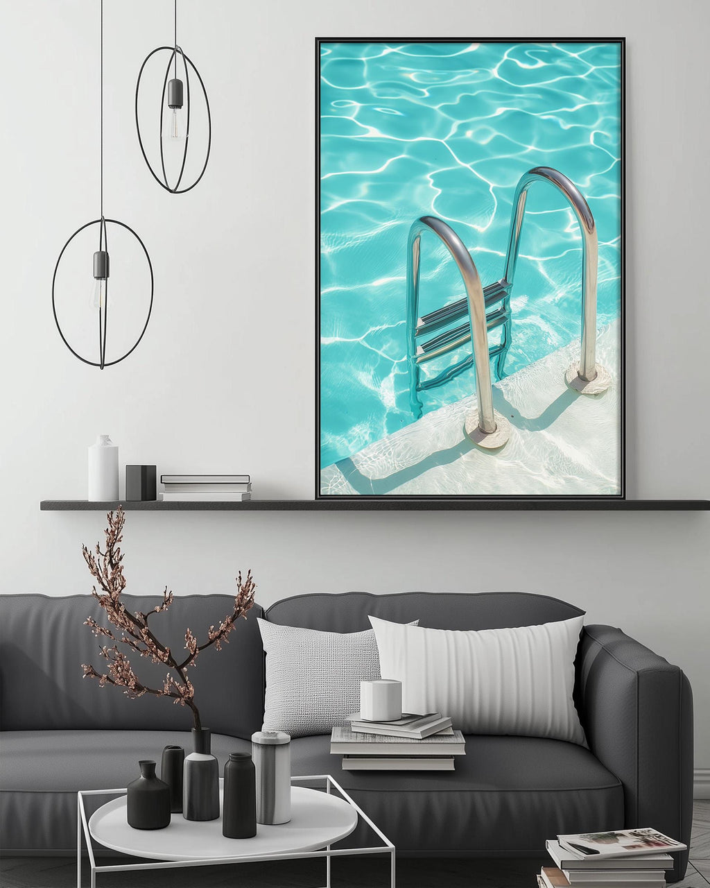 a modern living room with a gray sofa, a coffee table, and a large framed picture of a swimming pool with a ladder.