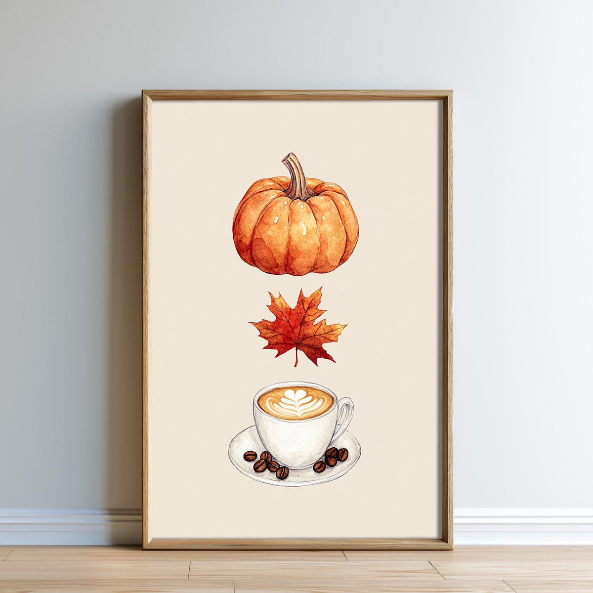 A framed print depicting a pumpkin, a maple leaf, and a cup of coffee, all set against a beige background.
