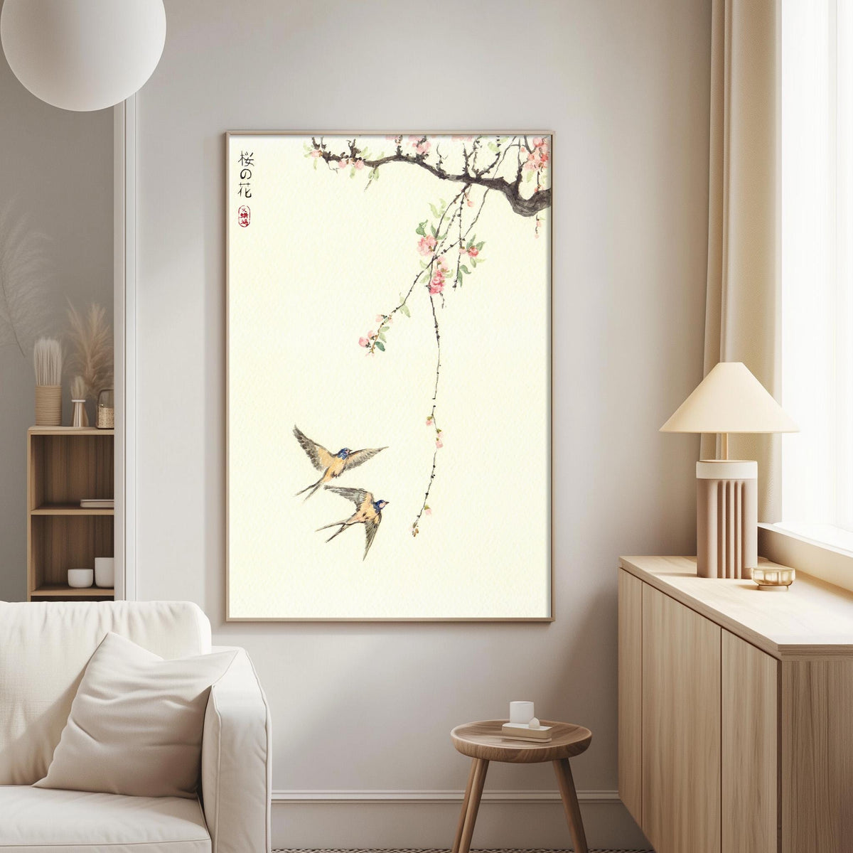 a living room with a large framed artwork of two birds in flight on the wall, along with a lamp and a small table.