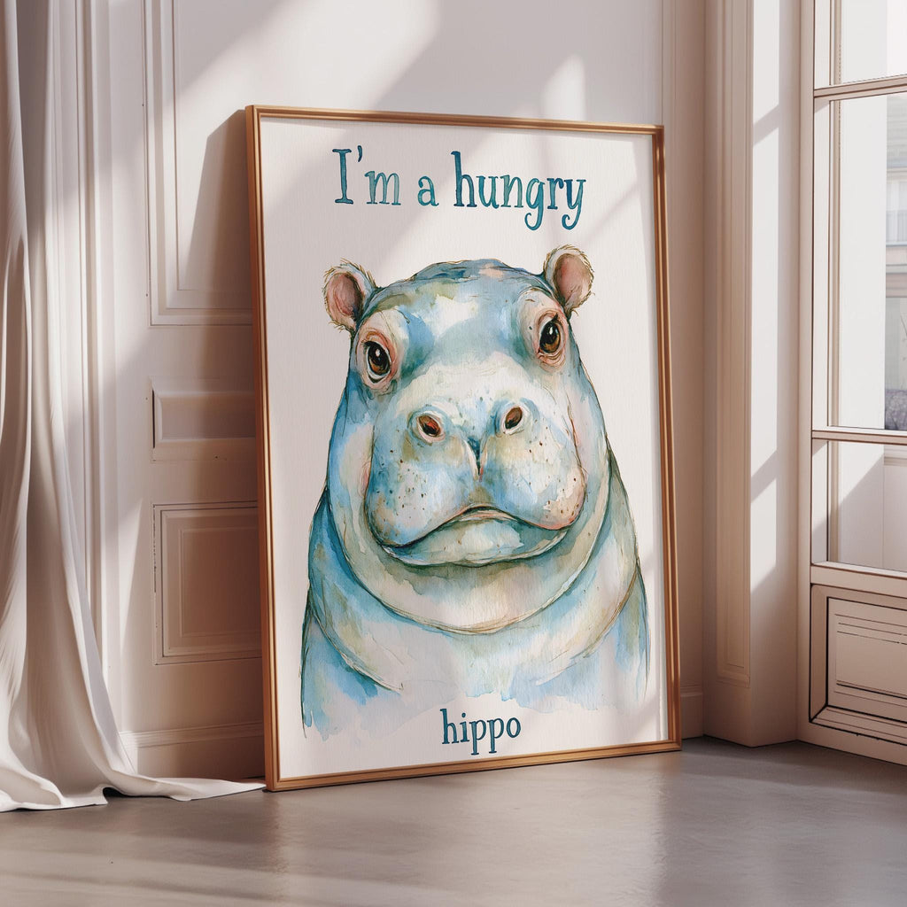 A framed watercolor painting of a hippopotamus with the text "I'm a hungry hippo" on it.