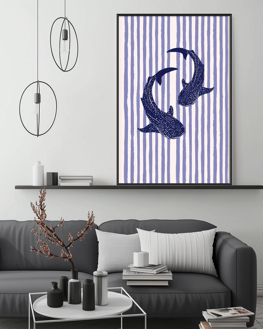 a modern living room with a gray sofa, a coffee table, and a large framed artwork depicting two blue sharks swimming against a striped background.