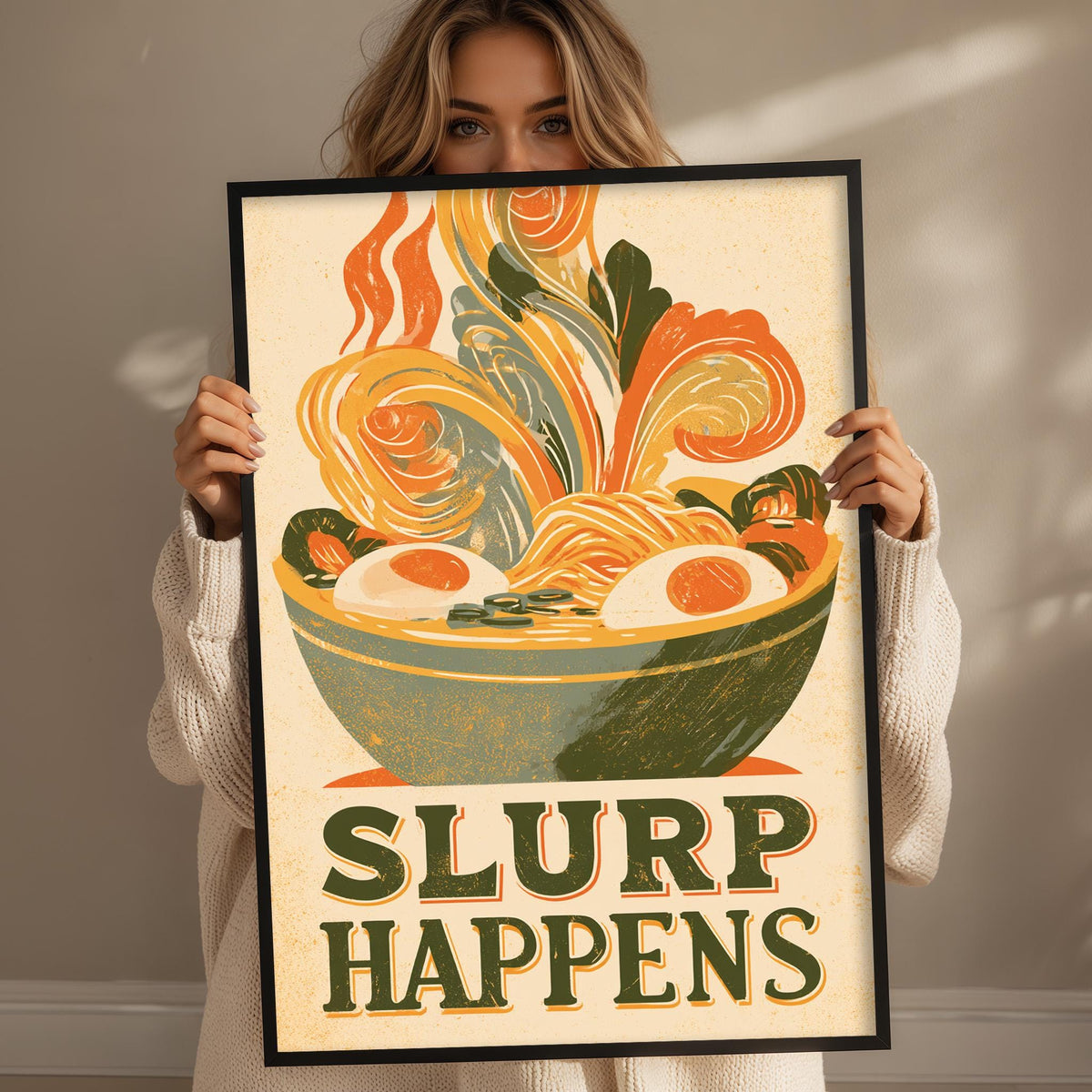 A woman holding a framed poster with a colorful illustration of a bowl of noodles and vegetables, along with the text "SLURP HAPPENS".