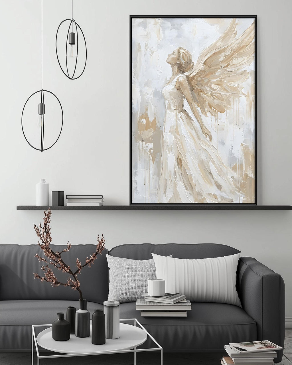 a modern living room with a gray sofa, a coffee table, and a large framed painting of an angel with outstretched wings hanging above the sofa.