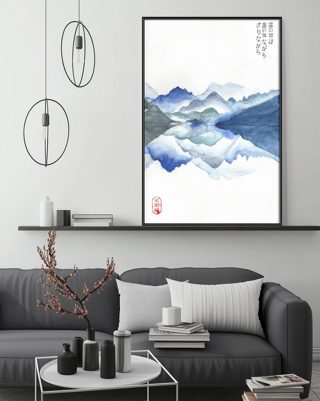 a modern living room with a gray sofa, a coffee table, and a large framed watercolor painting depicting a serene mountain landscape.