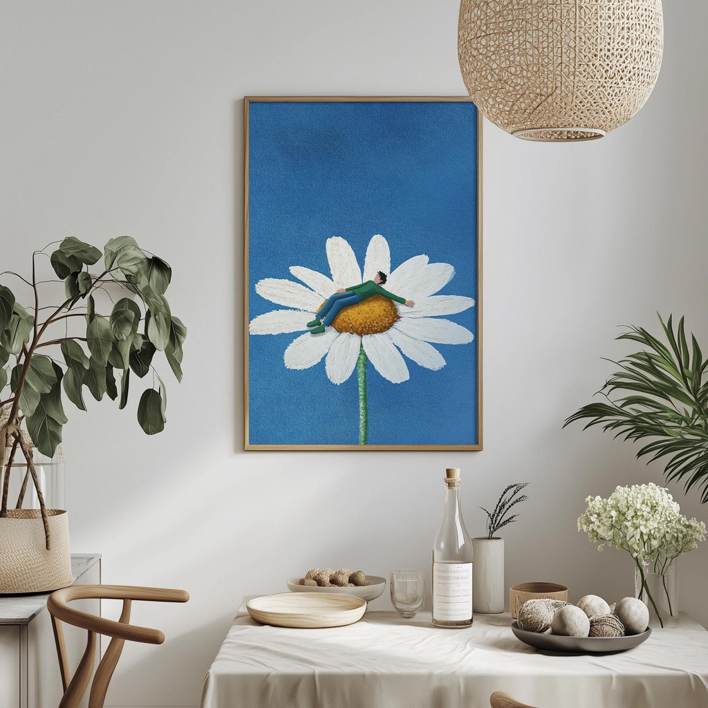 a dining table with a white tablecloth, a bowl of fruit, a bottle, and a vase with flowers. Above the table, there is a framed painting of a flower with a person sitting on it.