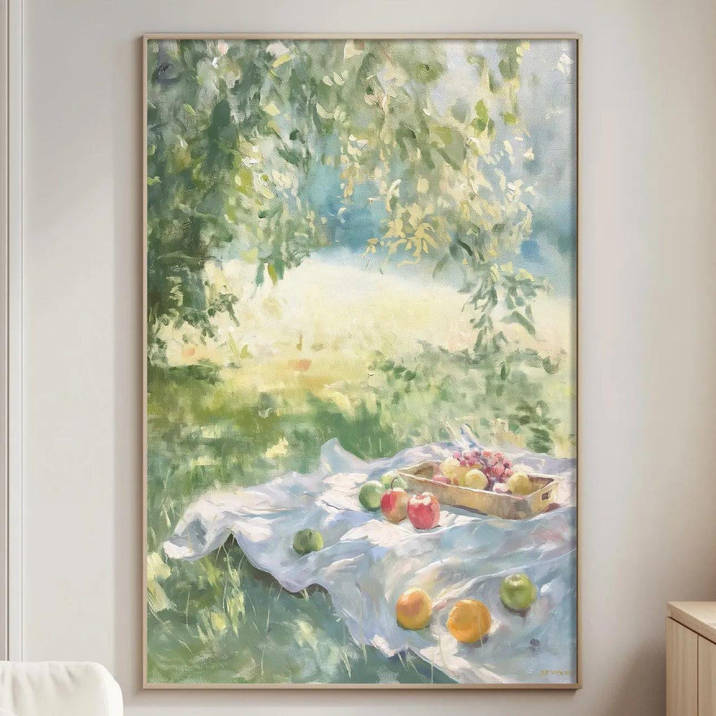 a cozy living room with a large painting of a picnic scene hanging on the wall. The painting shows a blanket spread out on the grass, with a basket of fruit and a tree in the background. The room has a white sofa, a wooden side table, and a lamp on a nearby table.