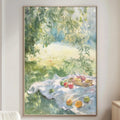 a cozy living room with a large painting of a picnic scene hanging on the wall. The painting shows a blanket spread out on the grass, with a basket of fruit and a tree in the background. The room has a white sofa, a wooden side table, and a lamp on a nearby table.