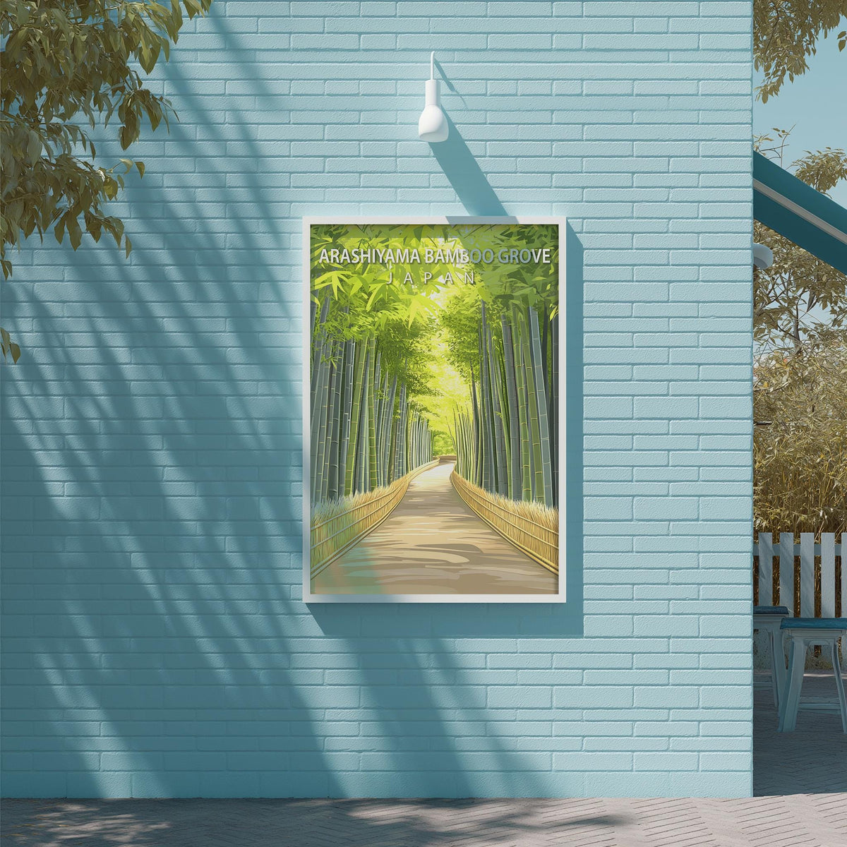 A framed poster of a bamboo forest path is displayed on a light blue wall, with a white light fixture above it.