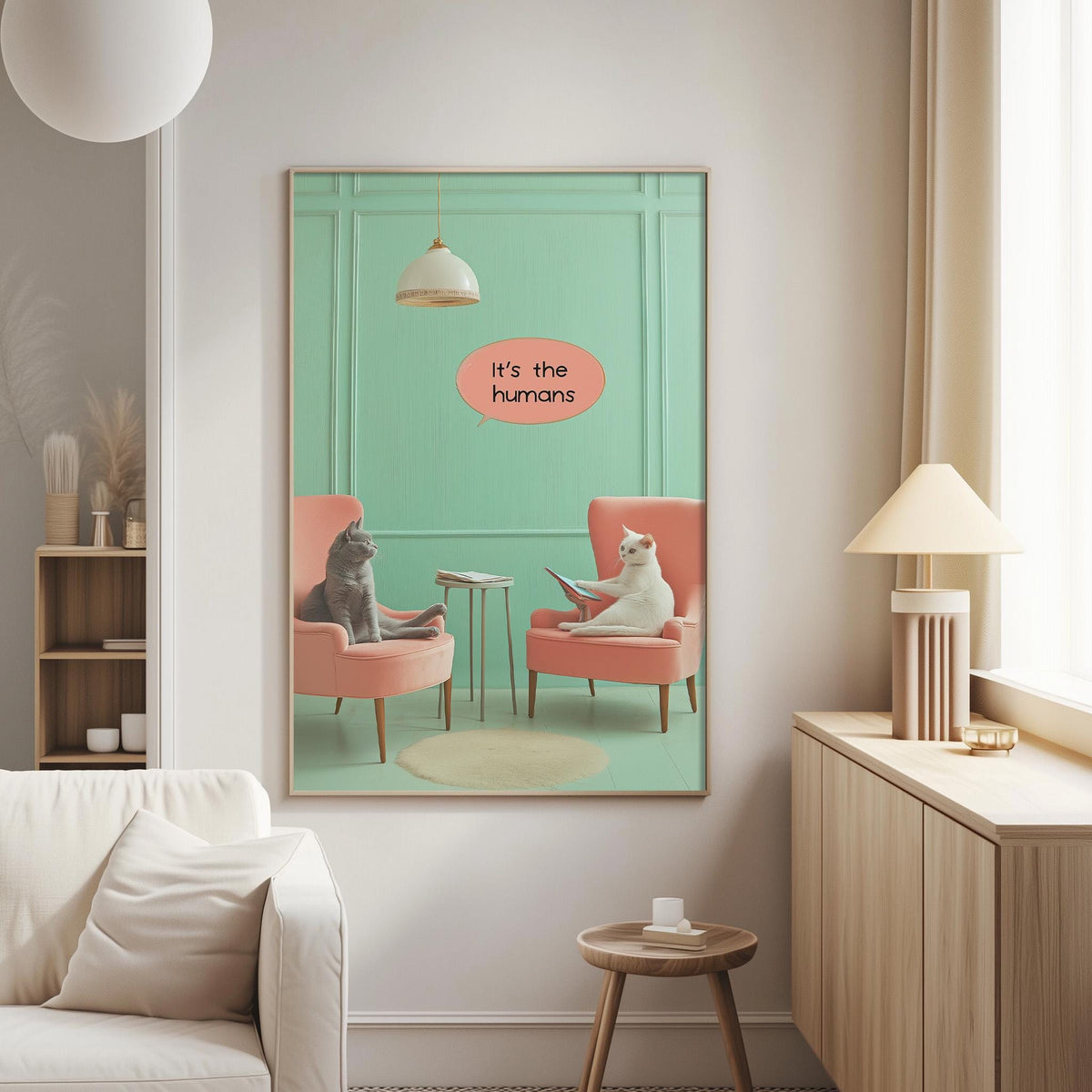 two cats sitting in chairs, with one cat reading a book and the other cat looking at it. The text above the image says "It's the humans".