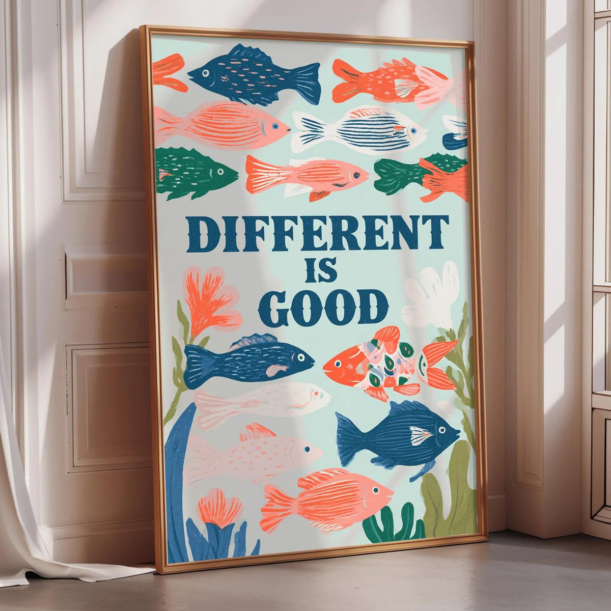 a poster with a colorful illustration of fish and plants, along with the text "DIFFERENT IS GOOD" displayed prominently.