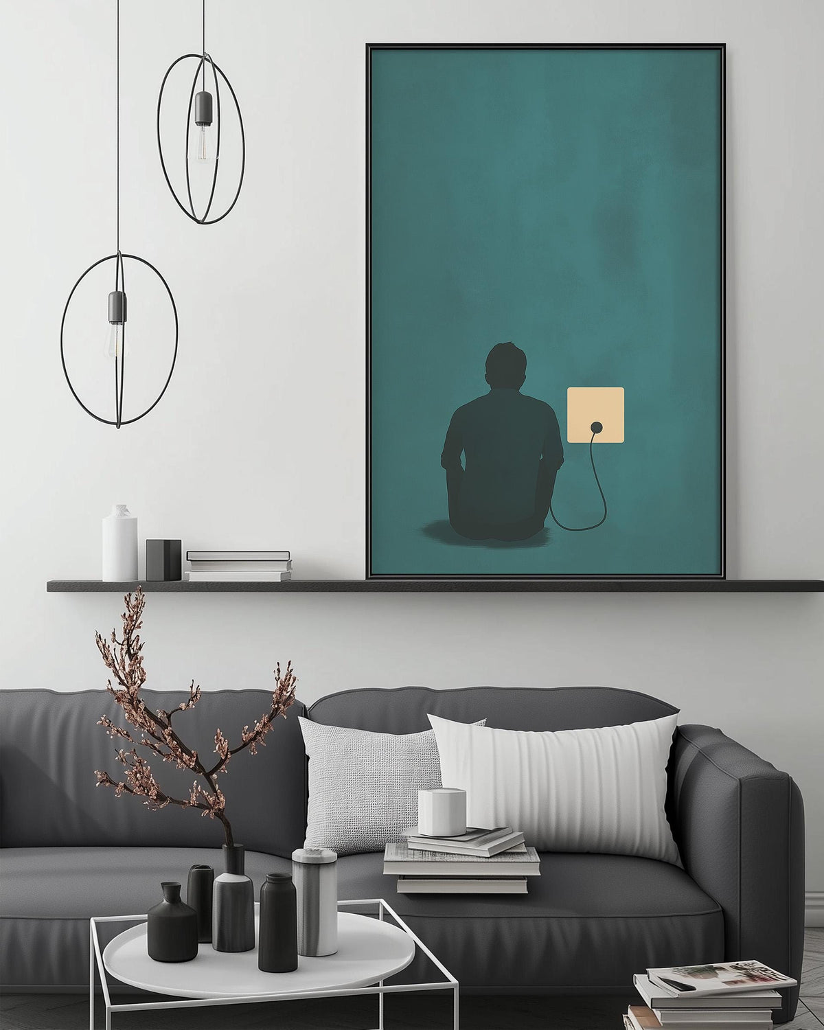 a modern living room with a gray sofa, a coffee table, and a large framed artwork depicting a silhouette of a person sitting in front of a computer monitor.
