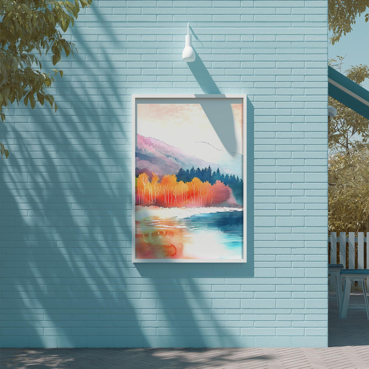 a blue brick wall with a framed painting of a landscape depicting a serene body of water surrounded by trees and mountains.