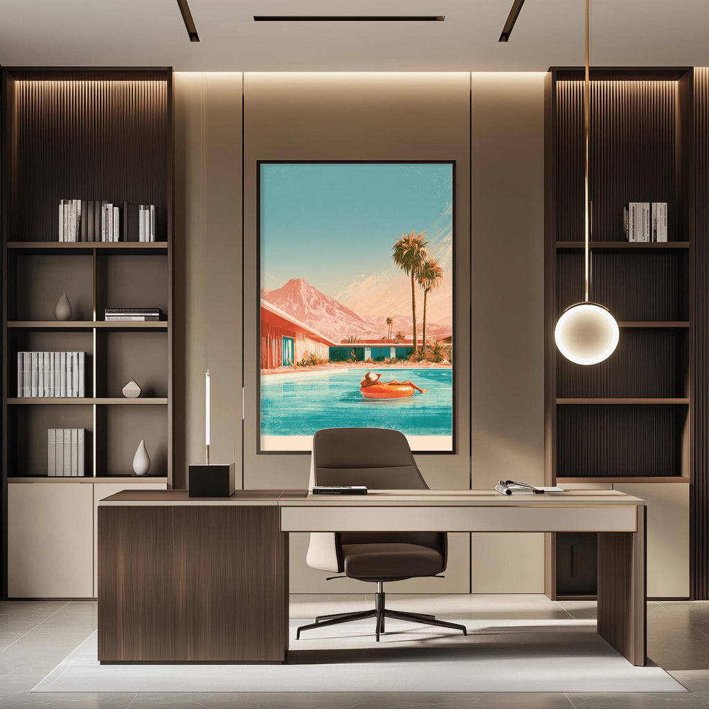 a modern office space with a large framed picture of a pool and palm trees hanging on the wall. The office has a wooden desk, a chair, and a bookshelf. The overall design has a contemporary and stylish aesthetic.