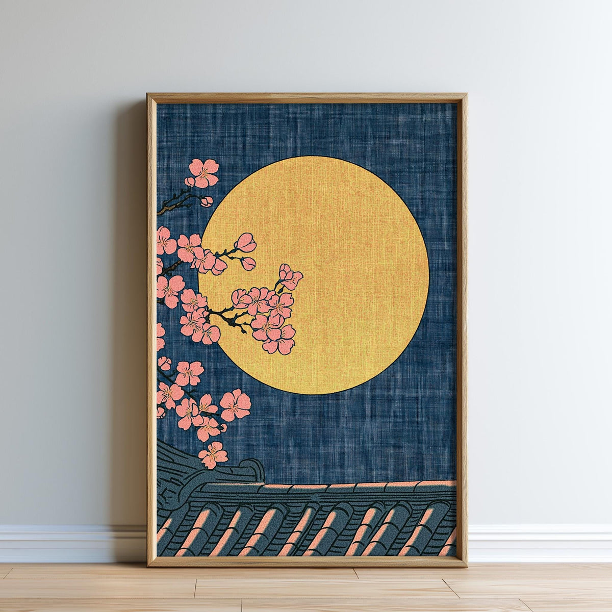 A framed illustration depicting a night scene with a large yellow moon, pink cherry blossoms, and a dark blue background.