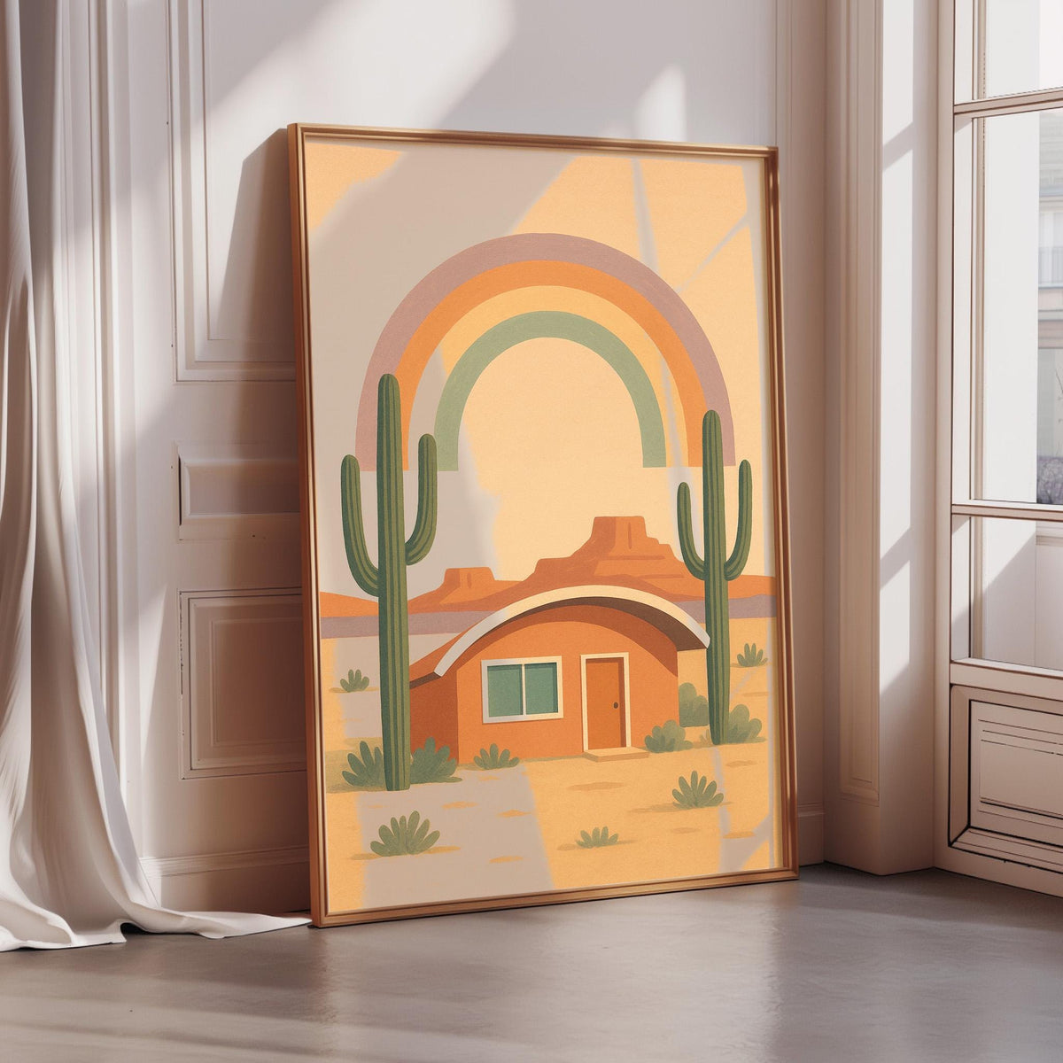 a framed illustration of a desert landscape with a cactus, a house, and a rainbow in the sky.