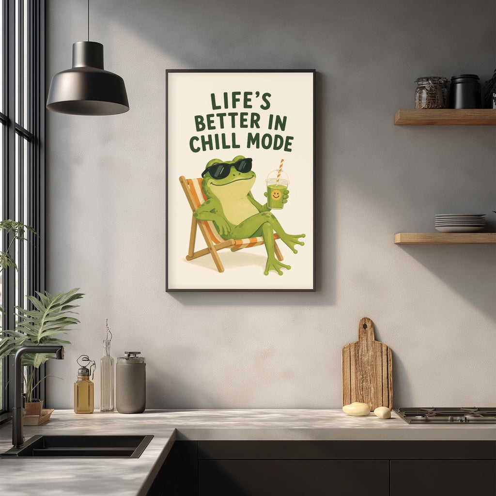 a framed poster with a green frog sitting in a chair, wearing sunglasses and holding a drink, with the text "Life's better in chill mode" written above it.