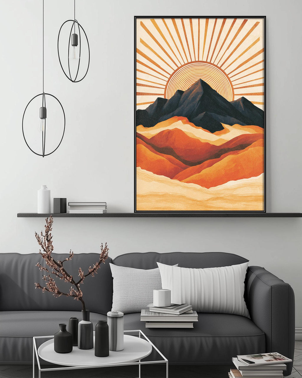 a modern living room with a gray sofa, a coffee table, and a large framed artwork depicting a mountain landscape with a sunburst design.