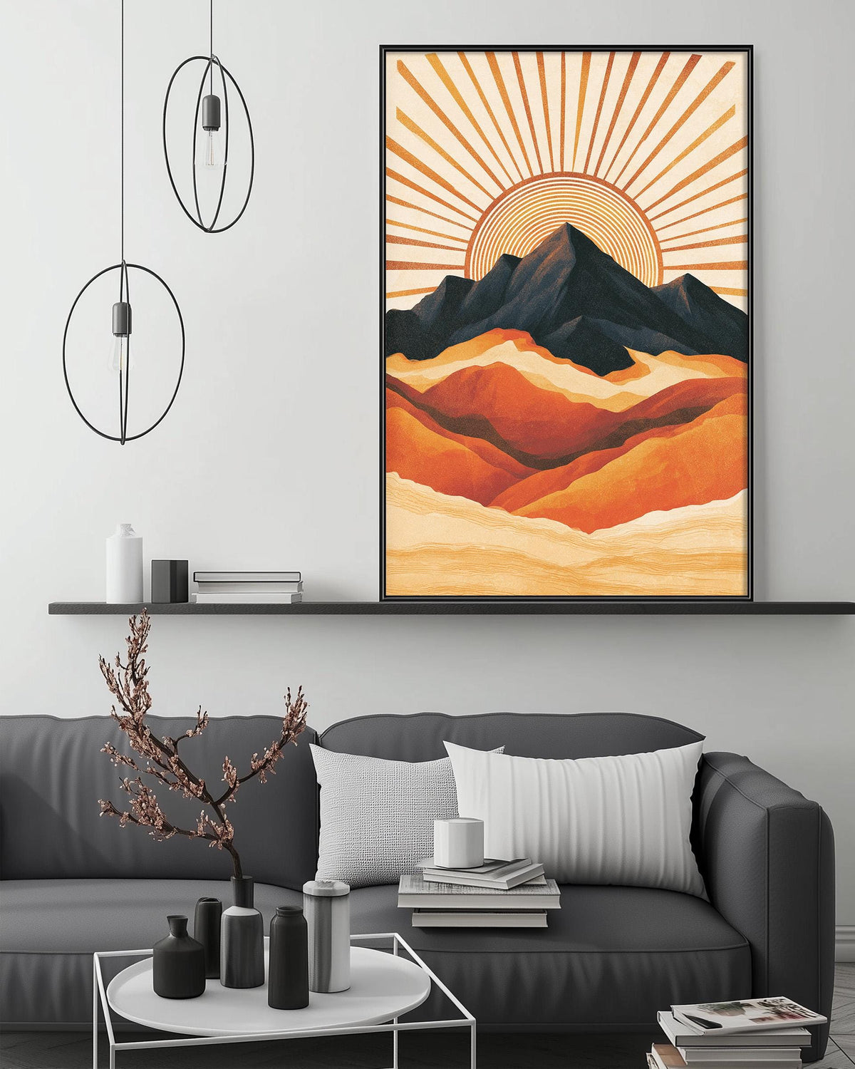 a modern living room with a gray sofa, a coffee table, and a large framed artwork depicting a mountain landscape with a sunburst design.